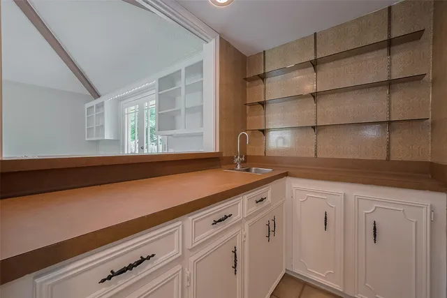 a kitchen with cabinets and window