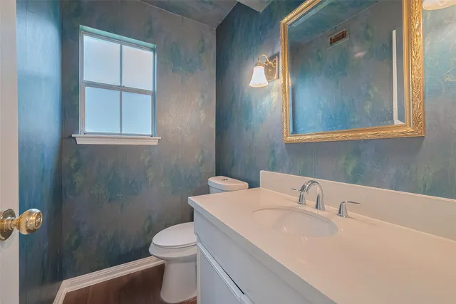 an empty room with windows and ceiling fan