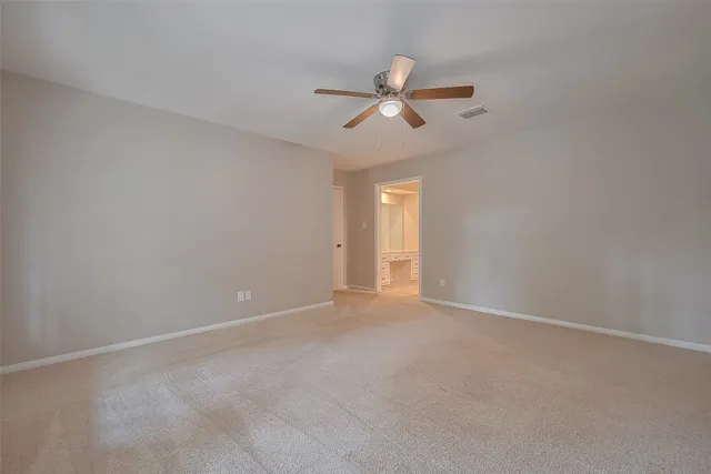 a view of a house with a yard and a tree