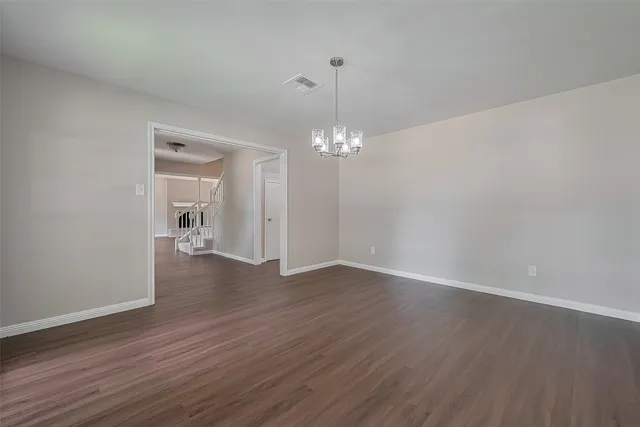 a view of empty room with wooden floor and fireplace
