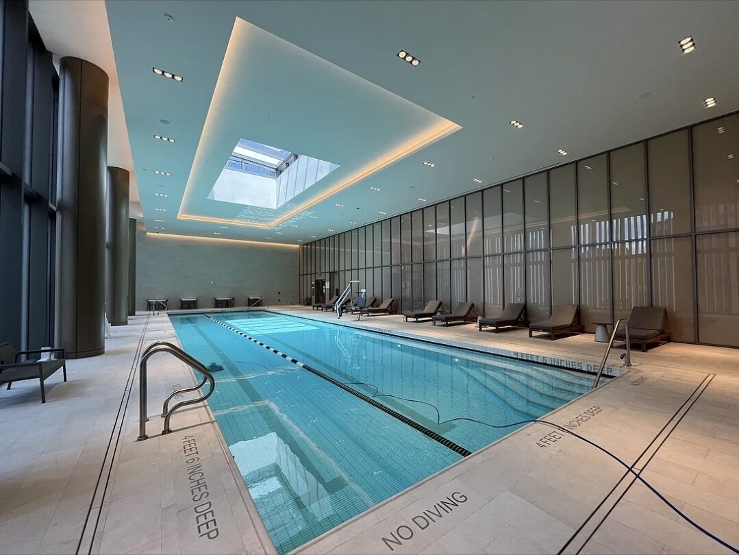 3 Court Square, Unit 2904 Queens, NY 11101 - Photo 5 of 12 a living room with a couch and a rug