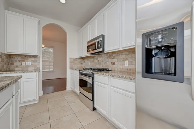 a kitchen with cabinets and appliances