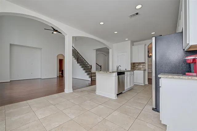 a view of kitchen with furniture and refrigerator