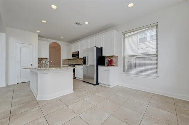 a kitchen with cabinets and stainless steel appliances