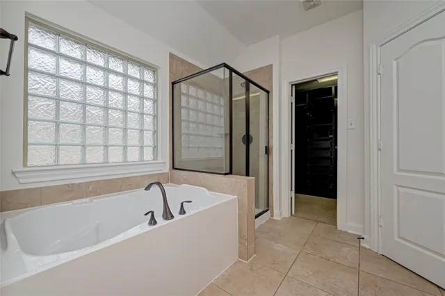 a bathroom with a bathtub and a shower
