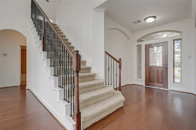 a view of entryway and hall with wooden floor
