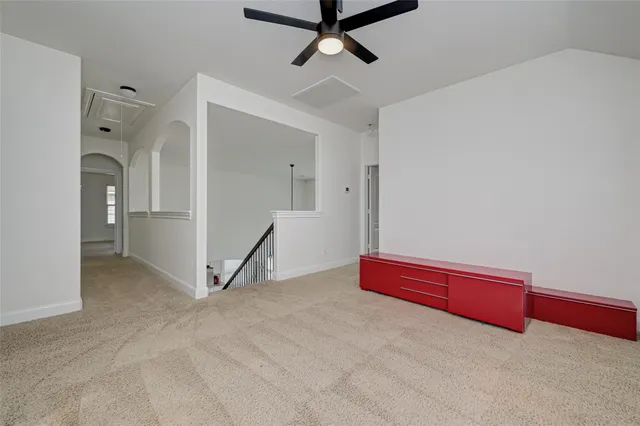 an empty room with closet and windows