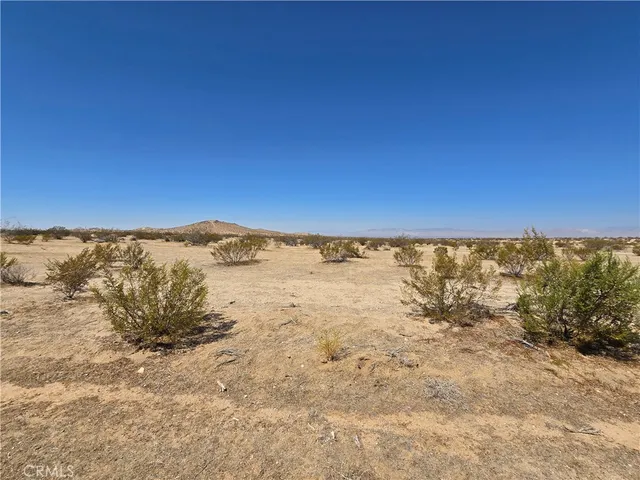 a view of a large building with mountains in the background