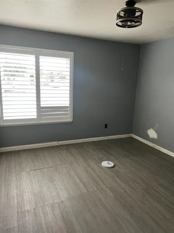 a view of a room with wooden floor and window