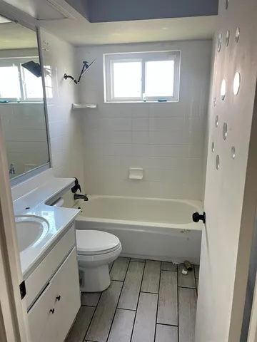 a bathroom with a sink a toilet and a bathtub