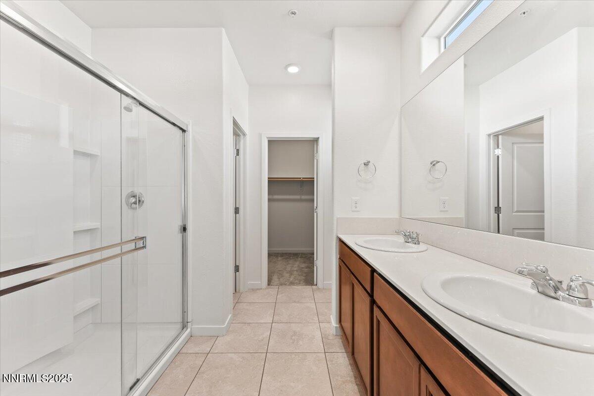 1048 Big Rock Loop Sun Valley, NV 89433 - Photo 15 of 25 a spacious bathroom with a double vanity sink a mirror and a shower