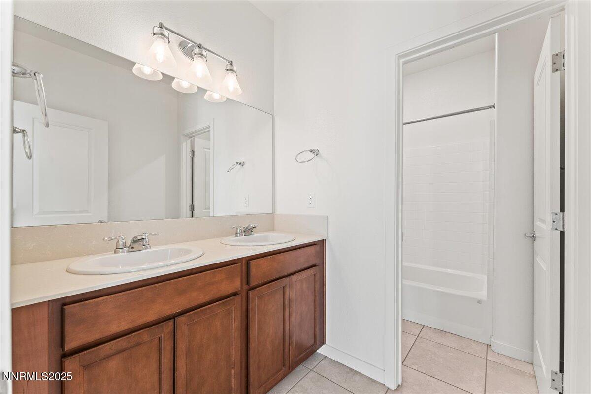 1048 Big Rock Loop Sun Valley, NV 89433 - Photo 17 of 25 a bathroom with a double vanity sink and a mirror
