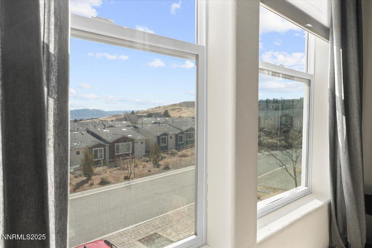 1048 Big Rock Loop Sun Valley, NV 89433 - Photo 22 of 25 a view of a glass door and a window