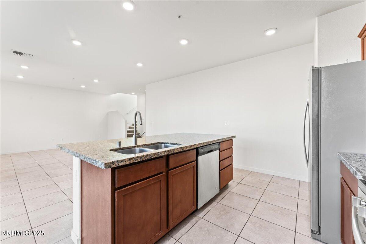 1048 Big Rock Loop Sun Valley, NV 89433 - Photo 6 of 25 a kitchen with a sink and refrigerator