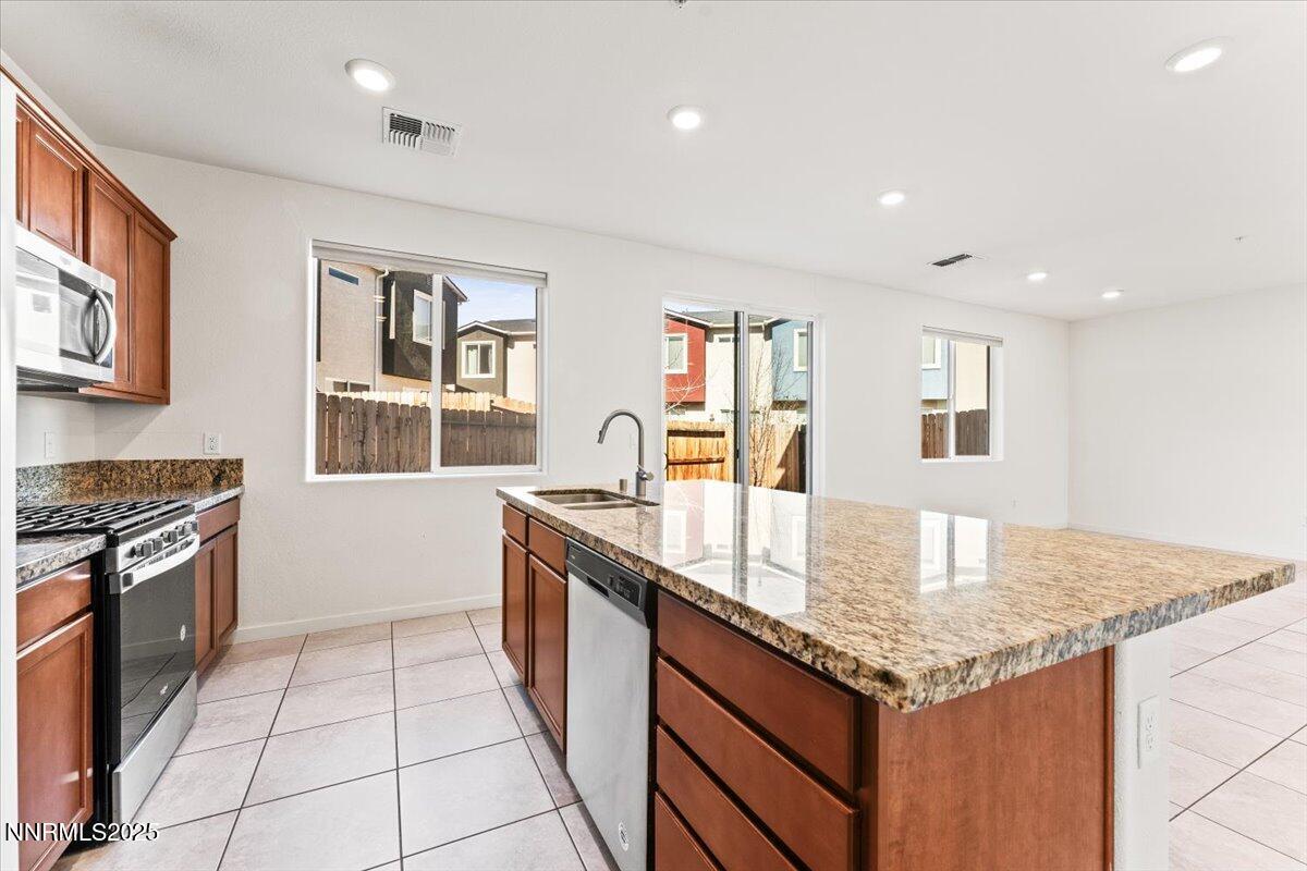 1048 Big Rock Loop Sun Valley, NV 89433 - Photo 7 of 25 a kitchen with granite countertop a stove and cabinets