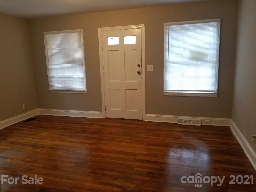 1135 Skyview Road Charlotte, NC 28208 - Photo 2 of 14 a view of an empty room with wooden floor and a window
