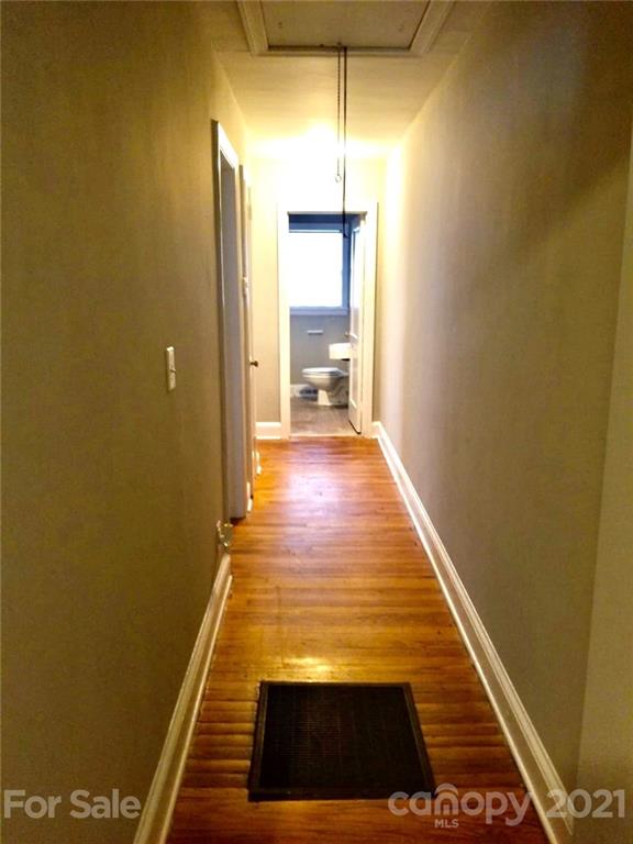 1135 Skyview Road Charlotte, NC 28208 - Photo 11 of 14 a view of a hallway with wooden floor