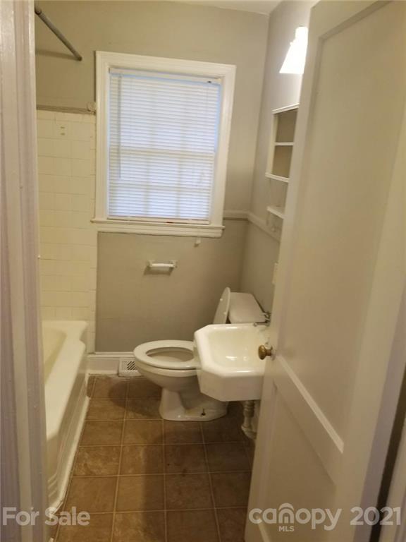 1135 Skyview Road Charlotte, NC 28208 - Photo 14 of 14 a bathroom with a sink a toilet and a shower