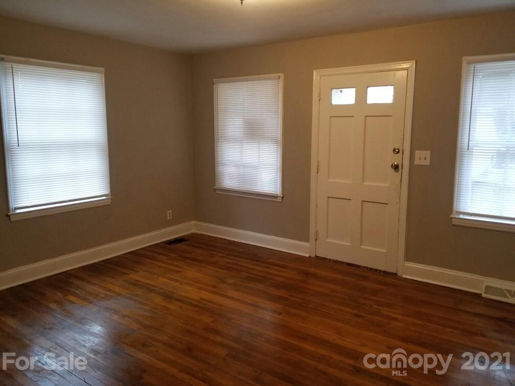 1135 Skyview Road Charlotte, NC 28208 - Photo 3 of 14 an empty room with wooden floor and windows