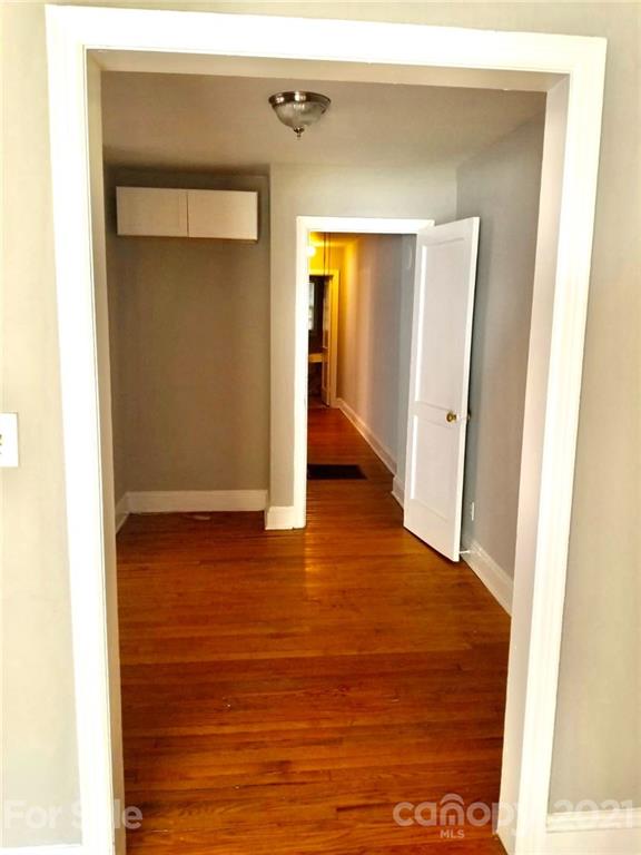 1135 Skyview Road Charlotte, NC 28208 - Photo 9 of 14 a view of a hallway with wooden floor