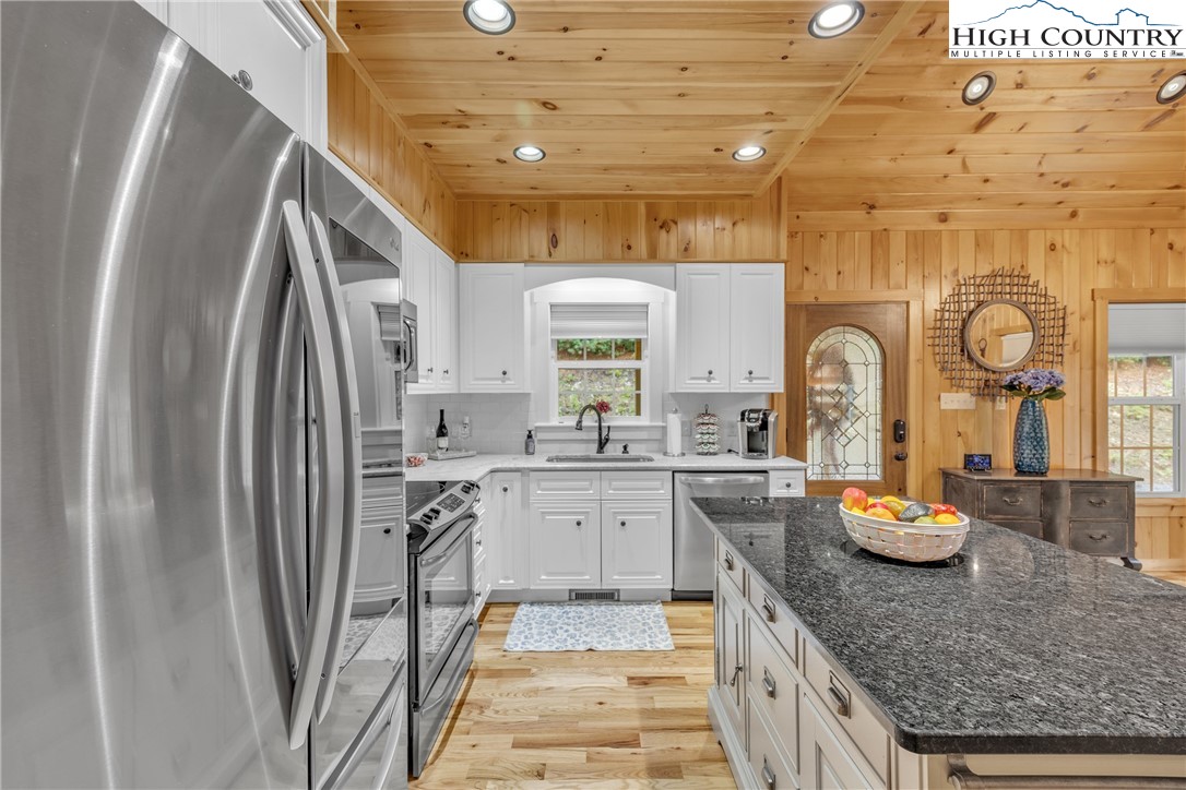 201 Eagles Nest Trail West Jefferson, NC 28694 - Photo 13 of 43 a kitchen with stainless steel appliances granite countertop a sink stove and refrigerator