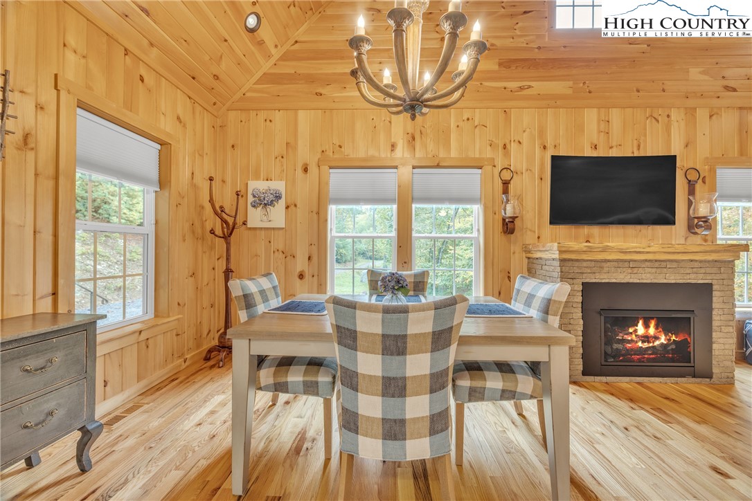 201 Eagles Nest Trail West Jefferson, NC 28694 - Photo 15 of 43 a living room with furniture a fireplace and a flat screen tv