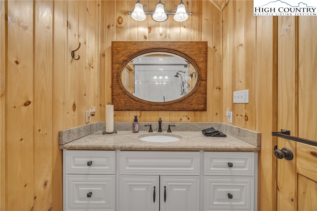 201 Eagles Nest Trail West Jefferson, NC 28694 - Photo 20 of 43 a bathroom with a granite countertop sink and a mirror