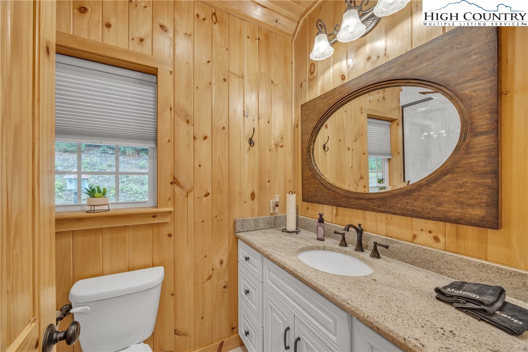 201 Eagles Nest Trail West Jefferson, NC 28694 - Photo 21 of 43 a bathroom with a granite countertop toilet a sink and a mirror