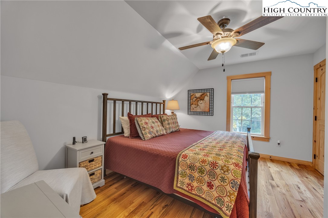 201 Eagles Nest Trail West Jefferson, NC 28694 - Photo 24 of 43 a bedroom with a bed and a chandelier