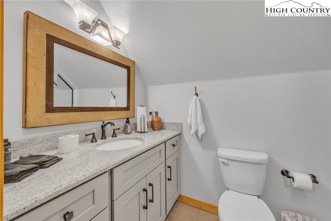 201 Eagles Nest Trail West Jefferson, NC 28694 - Photo 26 of 43 a bathroom with a toilet a sink and mirror