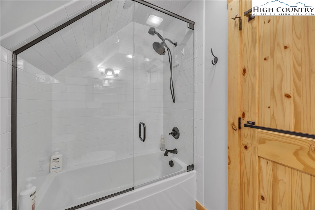 201 Eagles Nest Trail West Jefferson, NC 28694 - Photo 27 of 43 a bathroom with a glass shower door