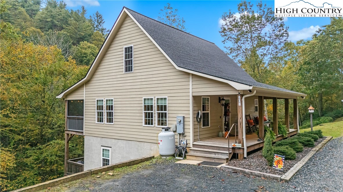 201 Eagles Nest Trail West Jefferson, NC 28694 - Photo 3 of 43 a view of small white building with large windows and plants