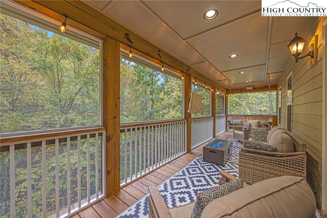 201 Eagles Nest Trail West Jefferson, NC 28694 - Photo 38 of 43 a balcony view with a couch and wooden floor