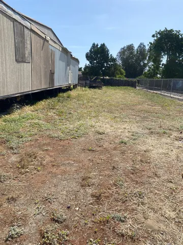 a view of a backyard of the house