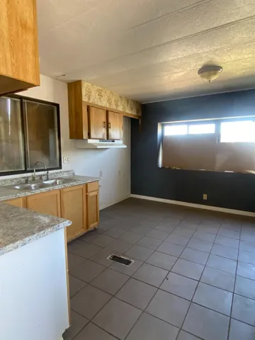 a view of a kitchen with a sink and cabinets