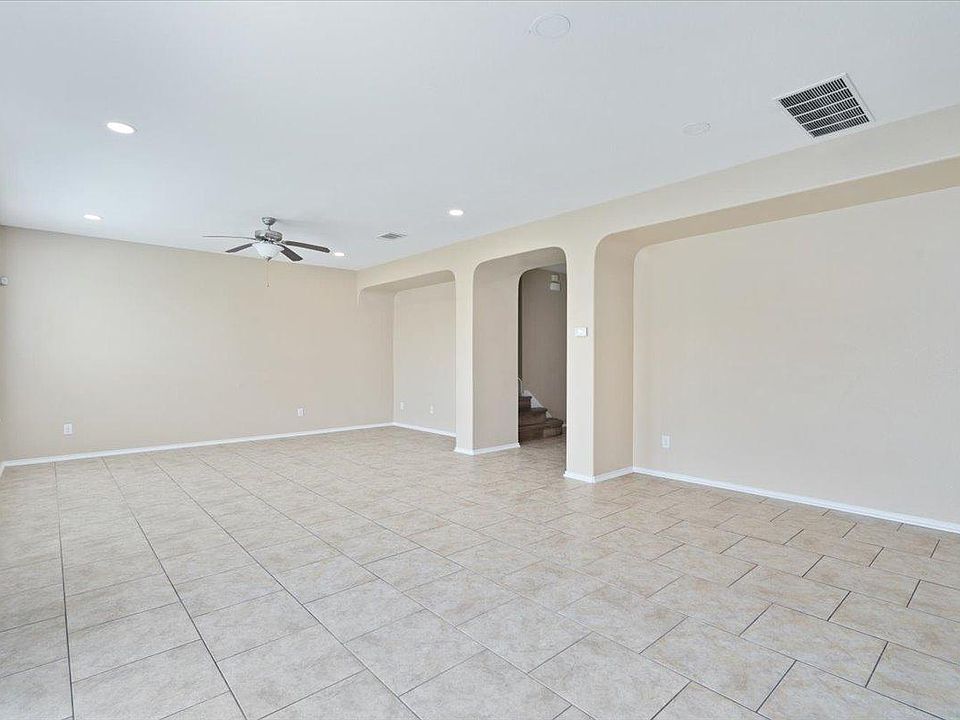 904 Lonesome Lilly Way Pflugerville, TX 78660 - Photo 11 of 34 Spacious interior with neutral-toned tiled flooring, recessed lighting, and a ceiling fan