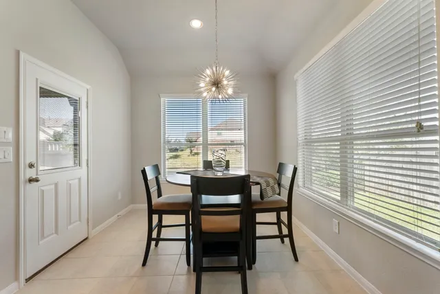 a view of a dining room with furniture and chandelier