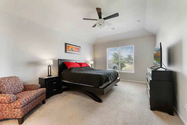 a bedroom with a bed and window