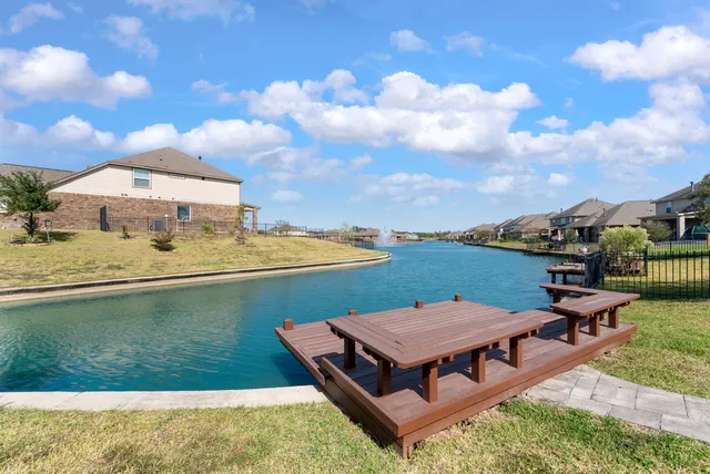 an aerial view of a house with pool garden and lake view