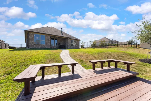 a view of a terrace with wooden floor and lake view