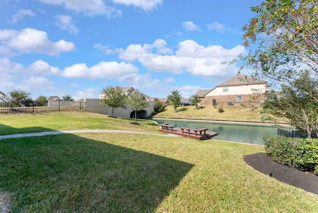 a view of swimming pool with outdoor seating and garden