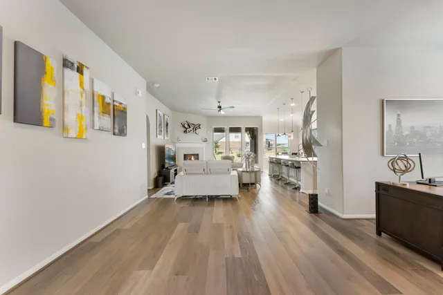 a view of a living room with furniture and wooden floor