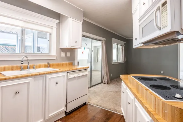 a kitchen with a sink stove and cabinets