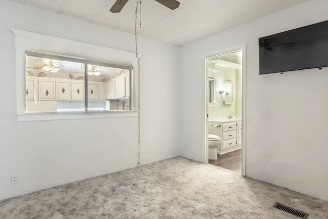 a view of a livingroom with wooden floor and a flat screen tv