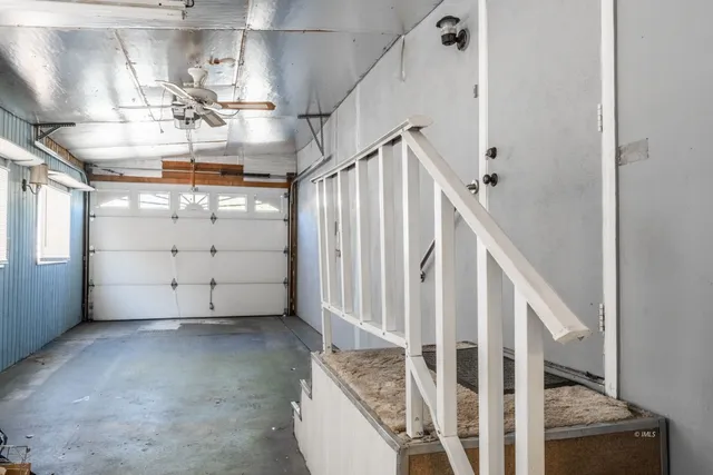 a kitchen with white cabinets and window