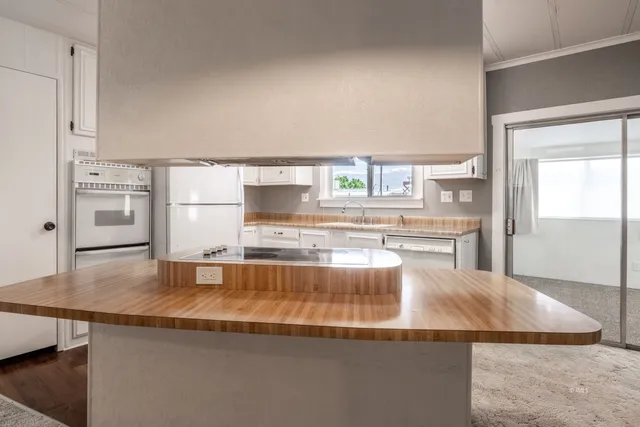 a kitchen with stainless steel appliances granite countertop a sink and a counter top