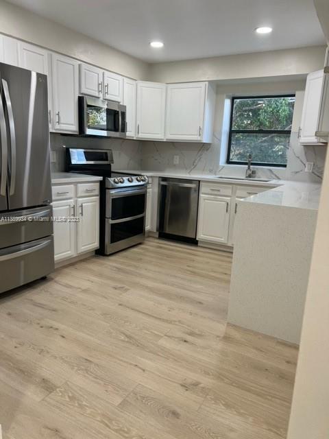 491 Racquet Club Road, Unit 312 Weston, FL 33326 - Photo 2 of 7 a kitchen with stainless steel appliances a refrigerator stove and microwave