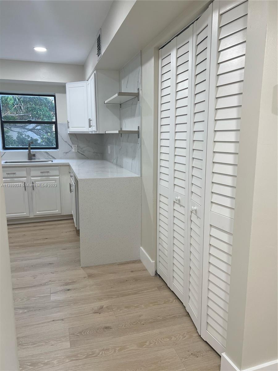 491 Racquet Club Road, Unit 312 Weston, FL 33326 - Photo 3 of 7 a view of cabinets with wooden floor