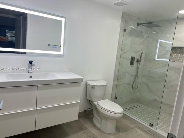 491 Racquet Club Road, Unit 312 Weston, FL 33326 - Photo 4 of 7 a bathroom with a sink a toilet and shower