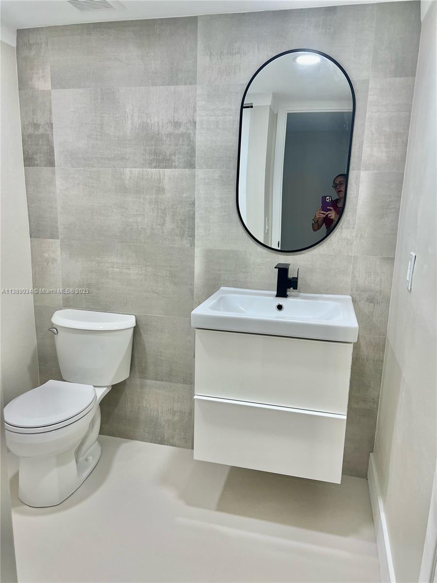 491 Racquet Club Road, Unit 312 Weston, FL 33326 - Photo 5 of 7 a bathroom with a sink and a mirror